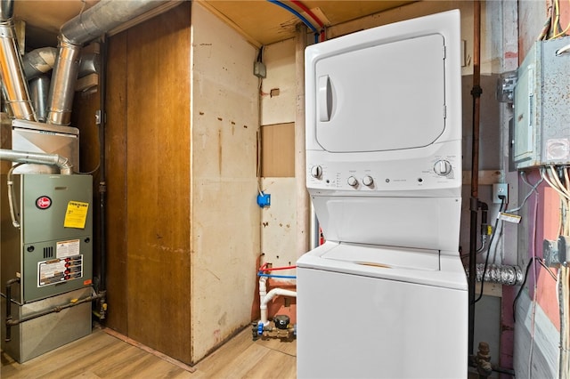 213 Auburn Ave, Gates, NY 14606 - laundry area with estacked washer and dryer and wood finished floors