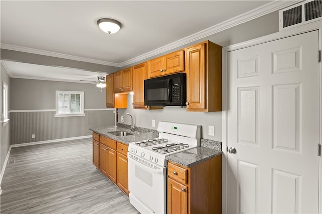 213 Auburn Ave, Gates, NY 14606 - kitchen featuring white gas stove, black microwave, light wood-type flooring, wainscoting, and ornamental molding