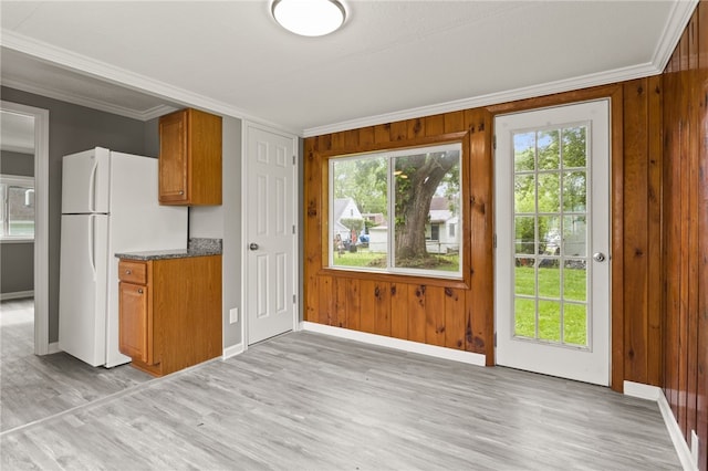 213 Auburn Ave, Gates, NY 14606 - kitchen with crown molding, freestanding refrigerator, light wood-type flooring, brown cabinets, and wooden walls