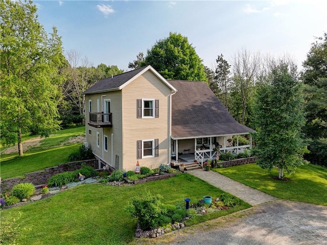 1544 Paddy Ln, Macedon, NY 14502 - view of front of property with a porch, a front lawn, and a balcony