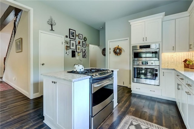 1544 Paddy Ln, Macedon, NY 14502 - kitchen with stainless steel appliances, dark wood-type flooring, light stone counters, and white cabinets