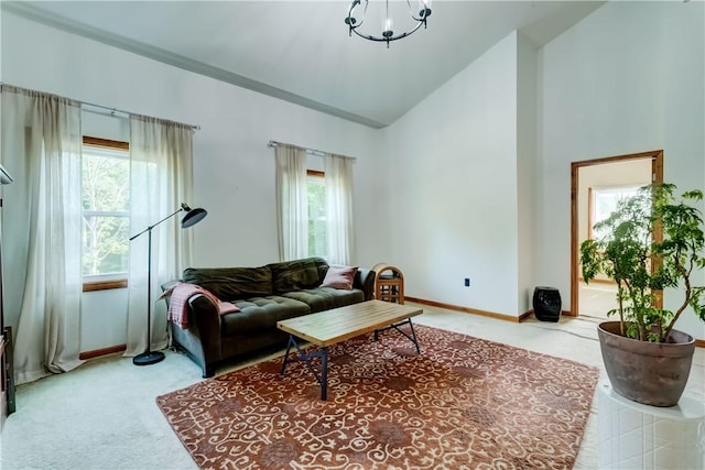 1544 Paddy Ln, Macedon, NY 14502 - carpeted living area featuring plenty of natural light, high vaulted ceiling, and a chandelier