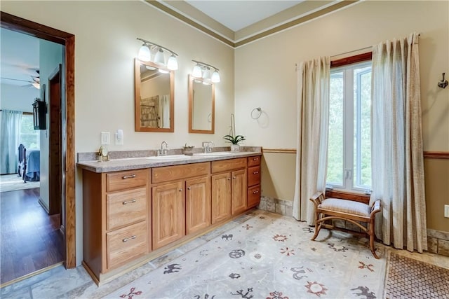 1544 Paddy Ln, Macedon, NY 14502 - ensuite bathroom featuring double vanity, plenty of natural light, a ceiling fan, and ornamental molding