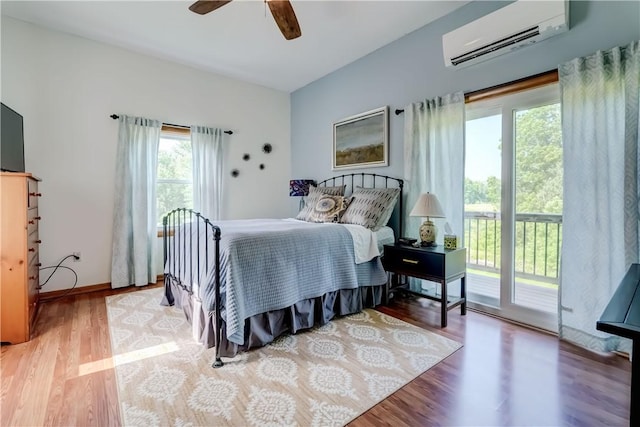 1544 Paddy Ln, Macedon, NY 14502 - bedroom featuring an AC wall unit, access to exterior, wood finished floors, and ceiling fan
