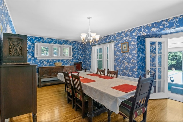 960 Landing Rd N, Brighton, NY 14625 - dining room featuring wallpapered walls, a chandelier, and wood finished floors