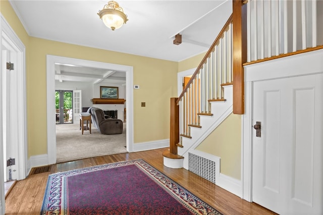 960 Landing Rd N, Brighton, NY 14625 - foyer featuring wood finished floors, beam ceiling, stairway, and a fireplace