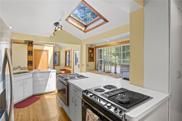 960 Landing Rd N, Brighton, NY 14625 - kitchen with stainless steel appliances, a skylight, light wood-style flooring, white cabinets, and light countertops