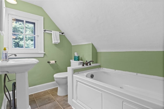 960 Landing Rd N, Brighton, NY 14625 - bathroom featuring vaulted ceiling, a tub with jets, and tile patterned flooring