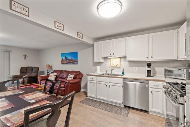 101 Post Lamp Cir, Cicero, NY 13212 - kitchen with stainless steel appliances, light wood-type flooring, white cabinets, open floor plan, and light countertops
