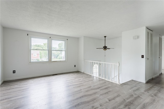 12 Rawhide Dr, Henrietta, NY 14586 - empty room with wood finished floors, a textured ceiling, and ceiling fan