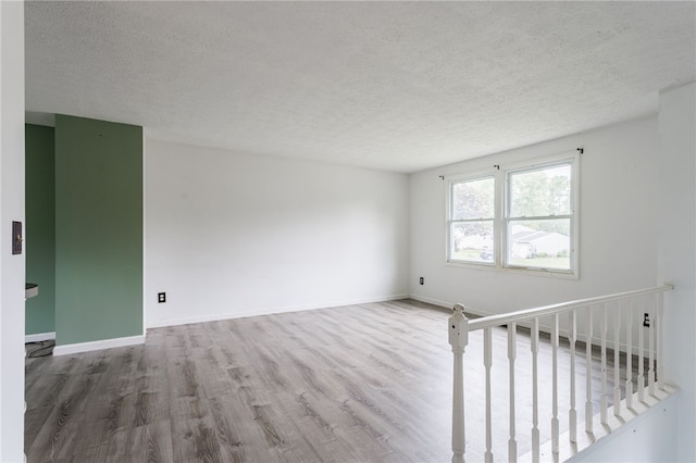 12 Rawhide Dr, Henrietta, NY 14586 - spare room featuring wood finished floors and a textured ceiling