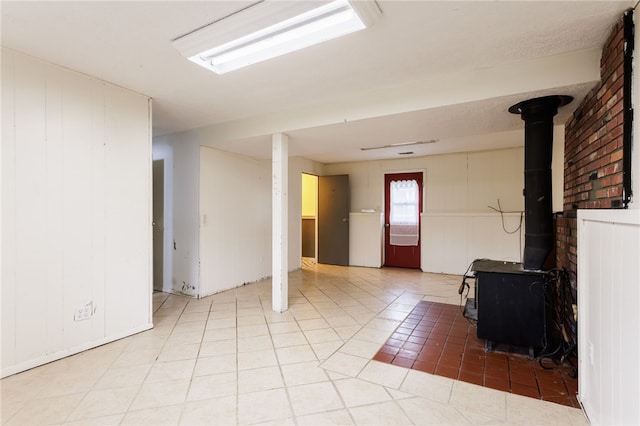 12 Rawhide Dr, Henrietta, NY 14586 - below grade area with a wood stove and light tile patterned floors