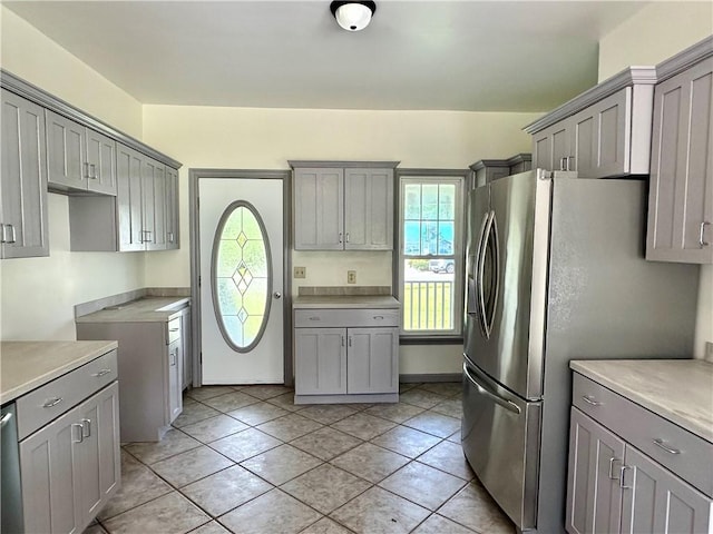 540 Derrick Rd, Foster-Town, PA 16701 - kitchen with gray cabinetry, freestanding refrigerator, and light tile patterned flooring