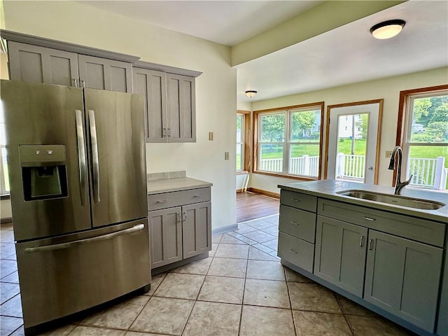 540 Derrick Rd, Foster-Town, PA 16701 - kitchen with stainless steel refrigerator with ice dispenser, gray cabinetry, light tile patterned floors, and light countertops