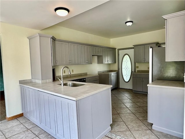 540 Derrick Rd, Foster-Town, PA 16701 - kitchen with gray cabinets, a peninsula, light tile patterned floors, and freestanding refrigerator