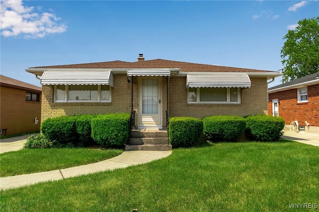 74 Lydia Ln, Cheektowaga, NY 14225 - bungalow-style house with brick siding, a front lawn, and a chimney