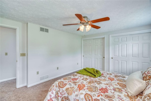 731 Brookeville Dr, Webster, NY 14580 - bedroom featuring carpet flooring, two closets, a textured ceiling, and ceiling fan