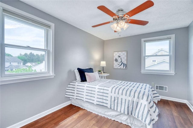 731 Brookeville Dr, Webster, NY 14580 - bedroom with multiple windows, wood finished floors, and ceiling fan