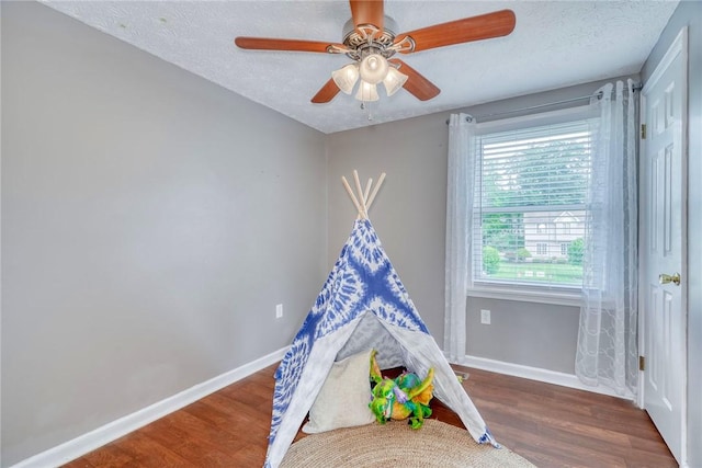 731 Brookeville Dr, Webster, NY 14580 - game room with wood finished floors, a ceiling fan, and a textured ceiling