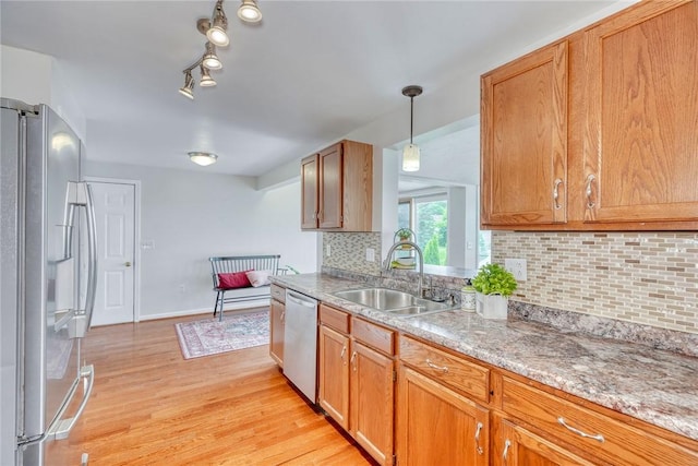 731 Brookeville Dr, Webster, NY 14580 - kitchen with appliances with stainless steel finishes, light wood-style flooring, backsplash, hanging light fixtures, and brown cabinets