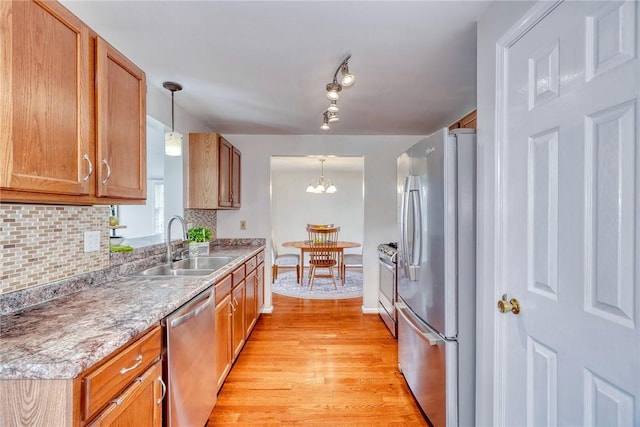 731 Brookeville Dr, Webster, NY 14580 - kitchen featuring stainless steel appliances, light wood-style flooring, decorative backsplash, and decorative light fixtures