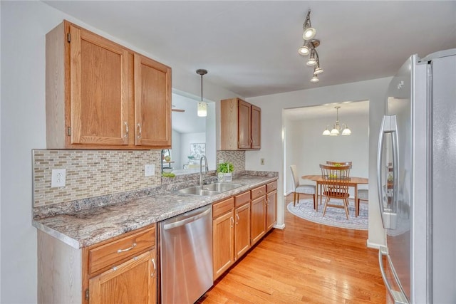 731 Brookeville Dr, Webster, NY 14580 - kitchen with appliances with stainless steel finishes, light wood-type flooring, decorative backsplash, hanging light fixtures, and light countertops