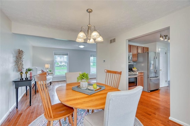 731 Brookeville Dr, Webster, NY 14580 - dining room featuring light wood-style floors and a chandelier