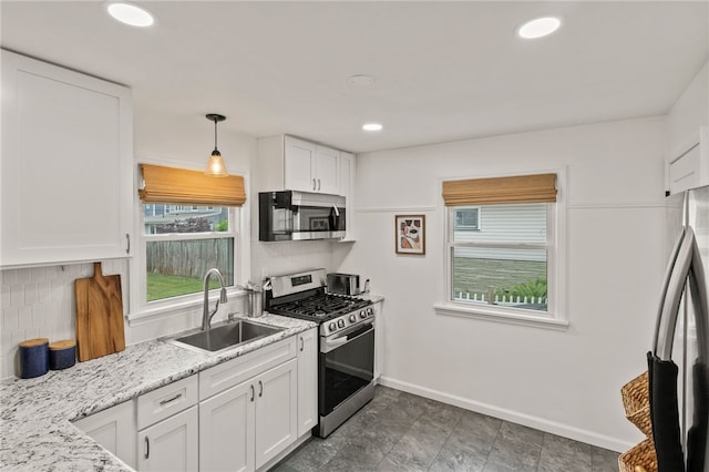 144 Montclair Dr, Irondequoit, NY 14617 - kitchen featuring stainless steel appliances, white cabinetry, backsplash, hanging light fixtures, and recessed lighting