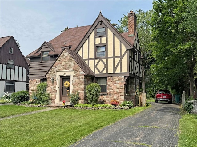 283 Bonnie Brae Ave, Brighton, NY 14618 - english style home featuring stone siding, stucco siding, a front yard, and a chimney