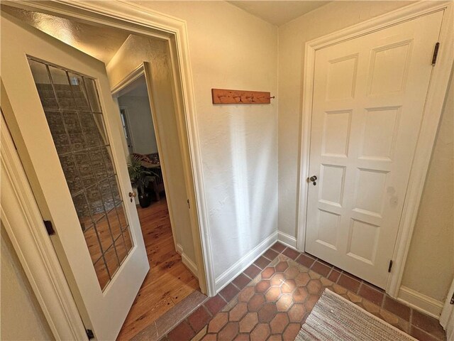 283 Bonnie Brae Ave, Brighton, NY 14618 - entryway featuring baseboards and dark tile patterned flooring
