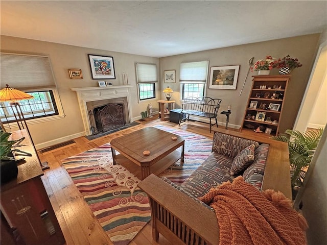 283 Bonnie Brae Ave, Brighton, NY 14618 - living room featuring plenty of natural light, wood finished floors, and a fireplace with flush hearth