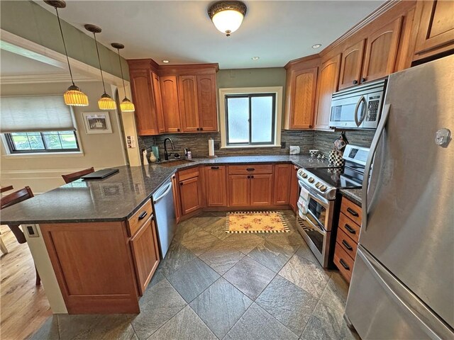 283 Bonnie Brae Ave, Brighton, NY 14618 - kitchen with appliances with stainless steel finishes, brown cabinets, backsplash, and a peninsula