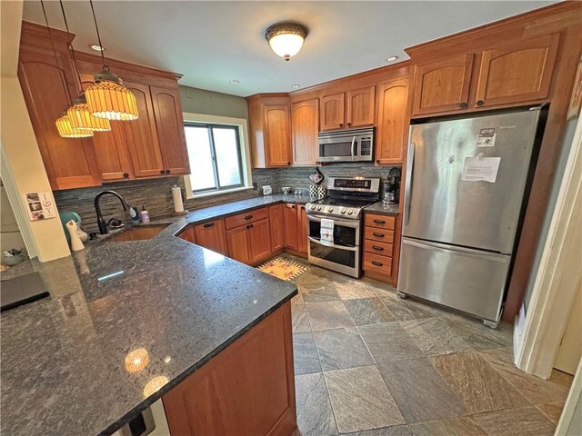 283 Bonnie Brae Ave, Brighton, NY 14618 - kitchen with stainless steel appliances, brown cabinets, dark stone countertops, and tasteful backsplash
