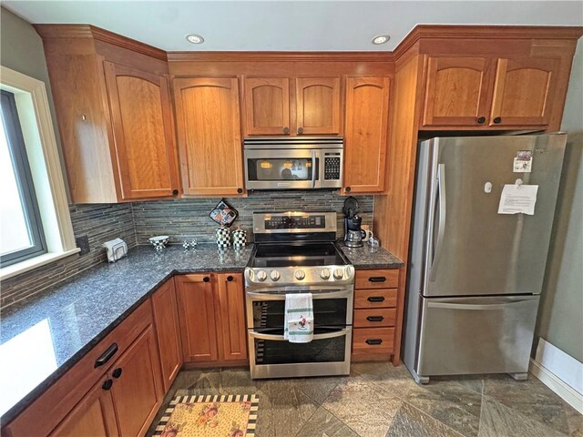 283 Bonnie Brae Ave, Brighton, NY 14618 - kitchen featuring stainless steel appliances, brown cabinets, tasteful backsplash, recessed lighting, and dark stone countertops