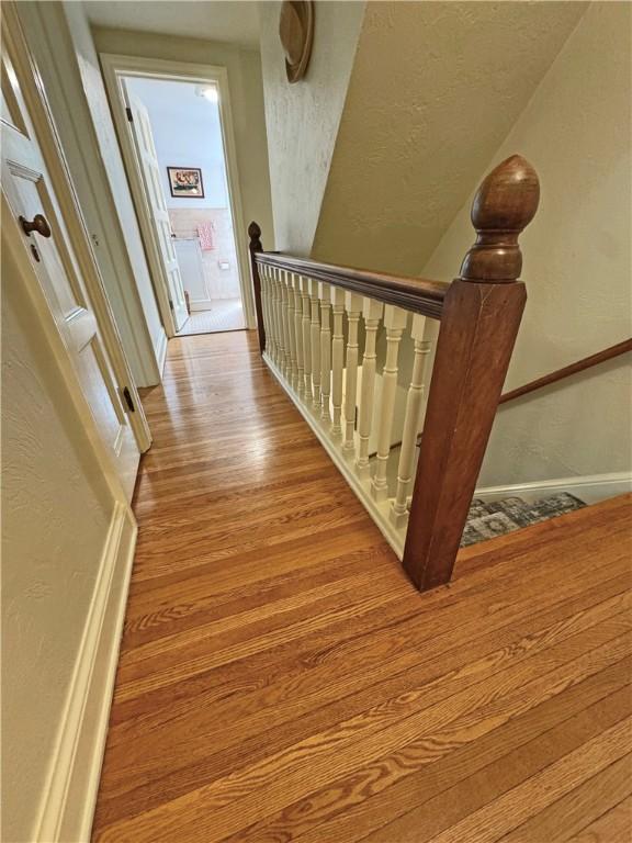 283 Bonnie Brae Ave, Brighton, NY 14618 - staircase featuring wood finished floors and a textured wall