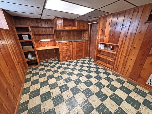 283 Bonnie Brae Ave, Brighton, NY 14618 - unfurnished office with wood walls, tile patterned floors, and a paneled ceiling