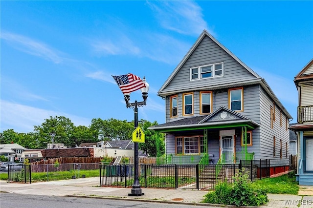 1083 E Lovejoy St, Buffalo, NY 14206 - american foursquare style home featuring a fenced front yard and covered porch
