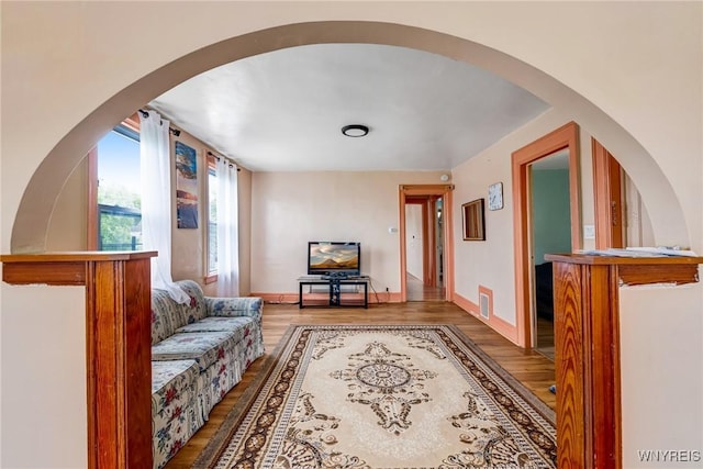 1083 E Lovejoy St, Buffalo, NY 14206 - living area featuring wood finished floors and arched walkways