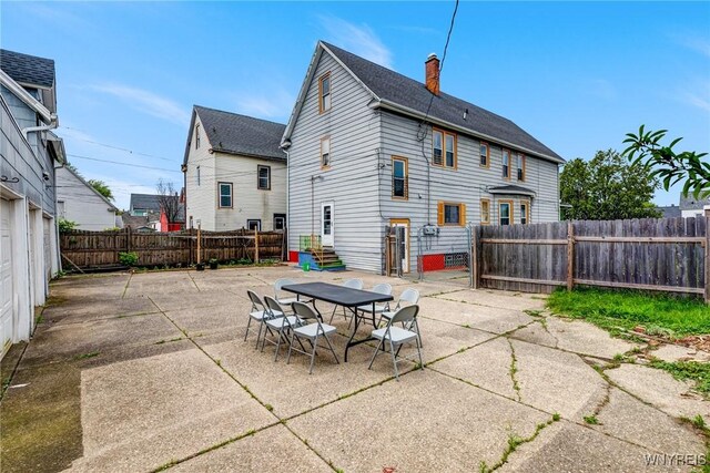 1083 E Lovejoy St, Buffalo, NY 14206 - rear view of property featuring a patio, a fenced backyard, a chimney, and entry steps