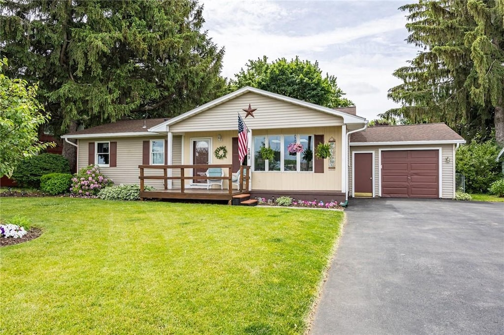 289 W Ave, Sweden, NY 14420 - single story home featuring an attached garage, driveway, a front lawn, and a deck