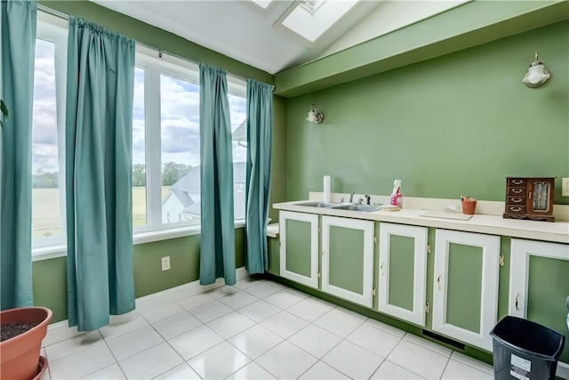 4618 Oak Orchard Rd, Barre, NY 14411 - kitchen featuring a skylight, healthy amount of natural light, light countertops, vaulted ceiling, and light tile patterned flooring