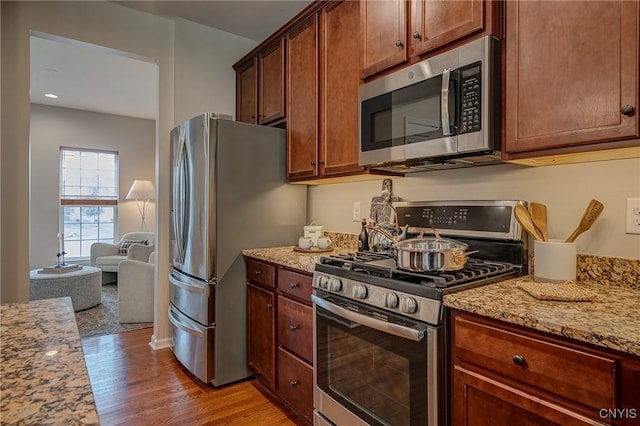8497 Melo Cir, Clay, NY 13041 - kitchen featuring appliances with stainless steel finishes, light wood finished floors, light stone counters, and recessed lighting