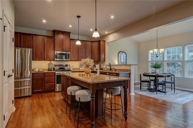 8497 Melo Cir, Clay, NY 13041 - kitchen with stainless steel appliances, dark wood-style floors, light stone counters, lofted ceiling, and recessed lighting