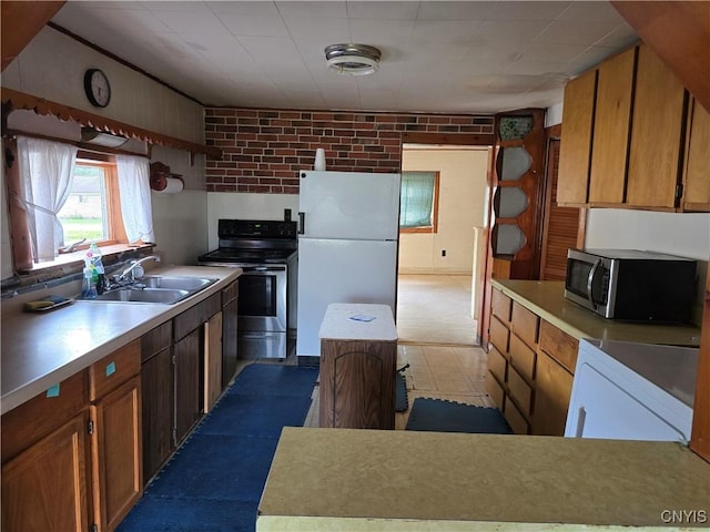 124 Seneca Ave, Sullivan, NY 13032 - kitchen featuring appliances with stainless steel finishes, dark flooring, light countertops, and brown cabinetry