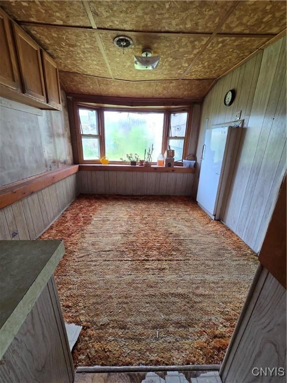 124 Seneca Ave, Sullivan, NY 13032 - corridor featuring carpet floors, wood walls, and an ornate ceiling