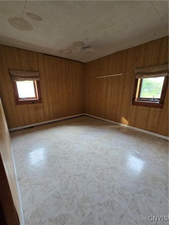 124 Seneca Ave, Sullivan, NY 13032 - spare room featuring tile patterned floors, healthy amount of natural light, and wooden walls