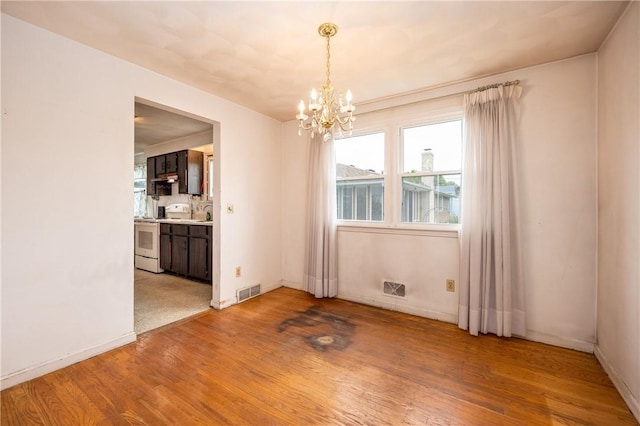 170 Kings S, Irondequoit, NY 14617 - empty room with wood finished floors and a chandelier
