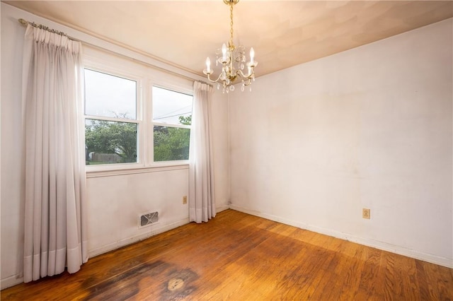 170 Kings S, Irondequoit, NY 14617 - unfurnished room featuring a chandelier and wood finished floors