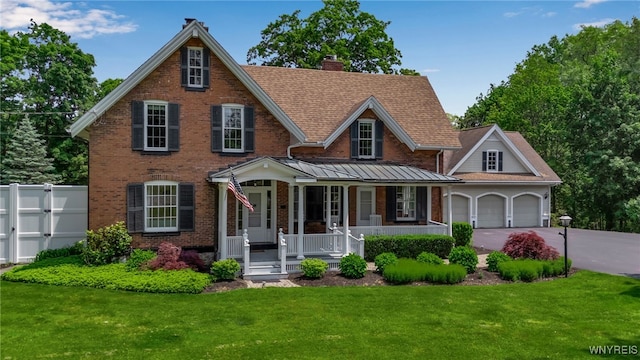 2565 Bowen Rd, Elma, NY 14059 - view of front of house with a porch, concrete driveway, brick siding, a chimney, and an attached garage