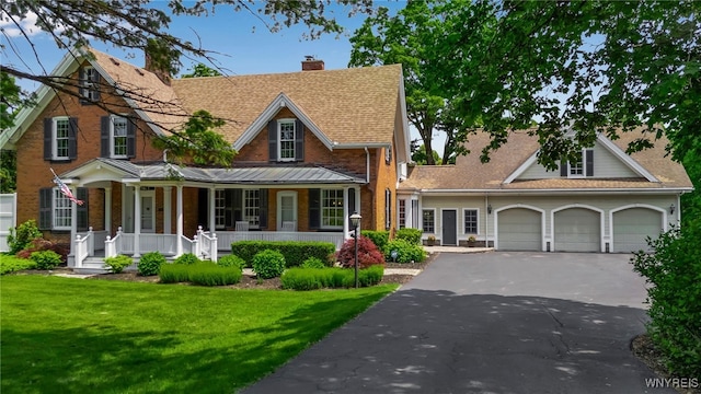 2565 Bowen Rd, Elma, NY 14059 - view of front of property featuring driveway, covered porch, an attached garage, a chimney, and a front yard